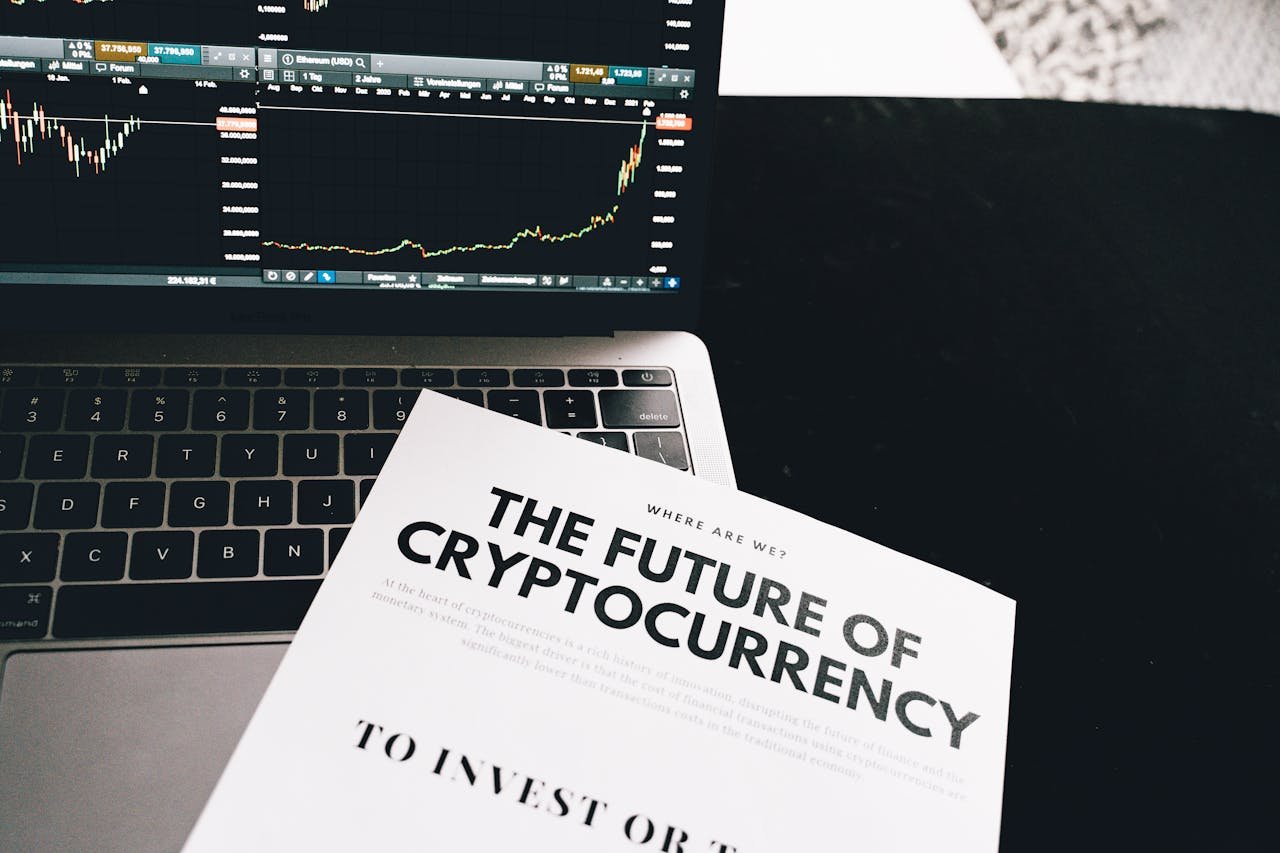 A detailed look at cryptocurrency market trends using a laptop and analytical document.